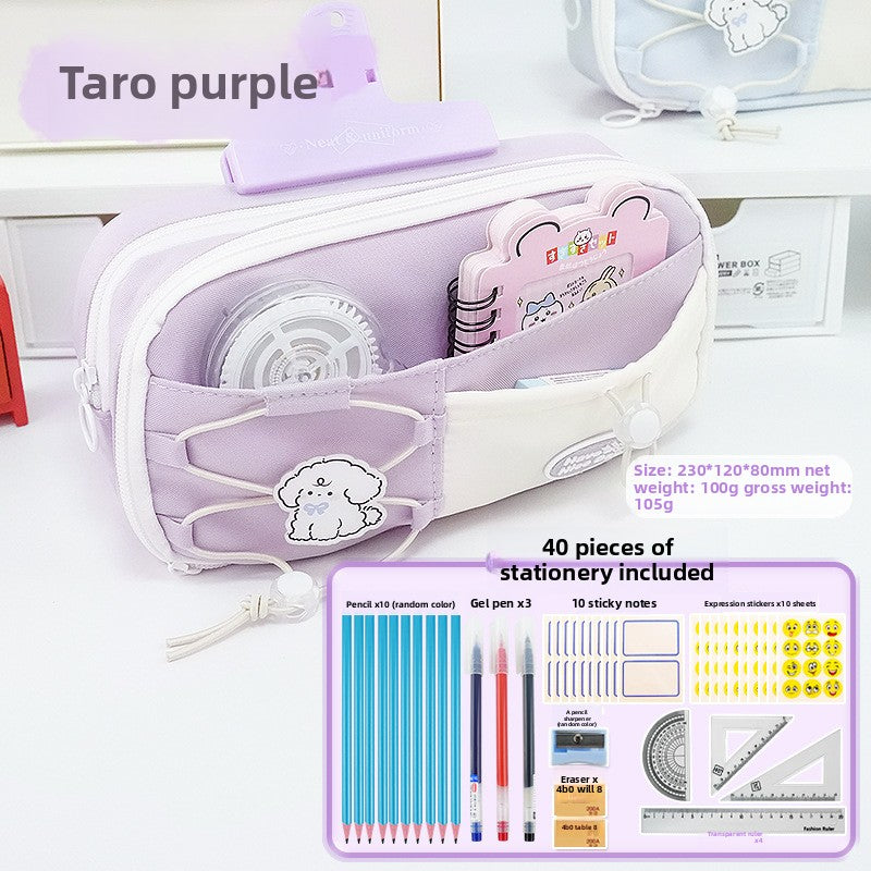 Taro Purple multi-compartment pencil case open showing interior pockets and accompanying stationery accessories
