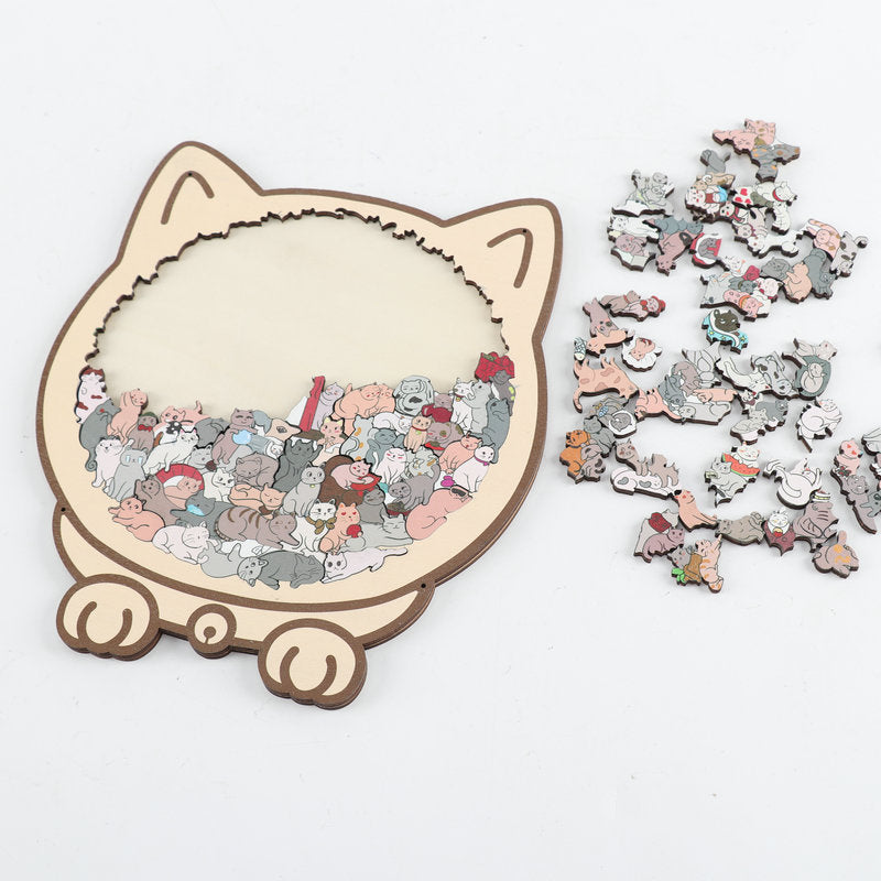 Partly assembled cat-shaped wooden jigsaw puzzle beside loose pieces, showing the fitting process