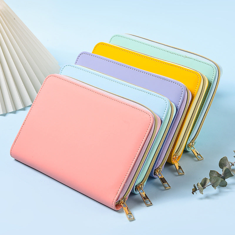 Pastel A5 zip-around notebook organisers in pink, blue, purple, yellow and mint green, stacked together