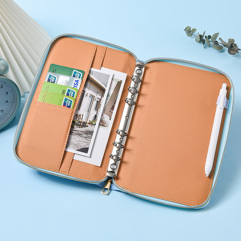 Open A5 zip-around notebook organiser showing ring binder, card pockets and pen holder